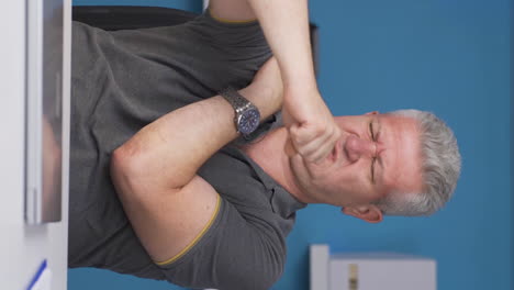 Vertical-video-of-Home-office-worker-man-has-shoulder-pain.